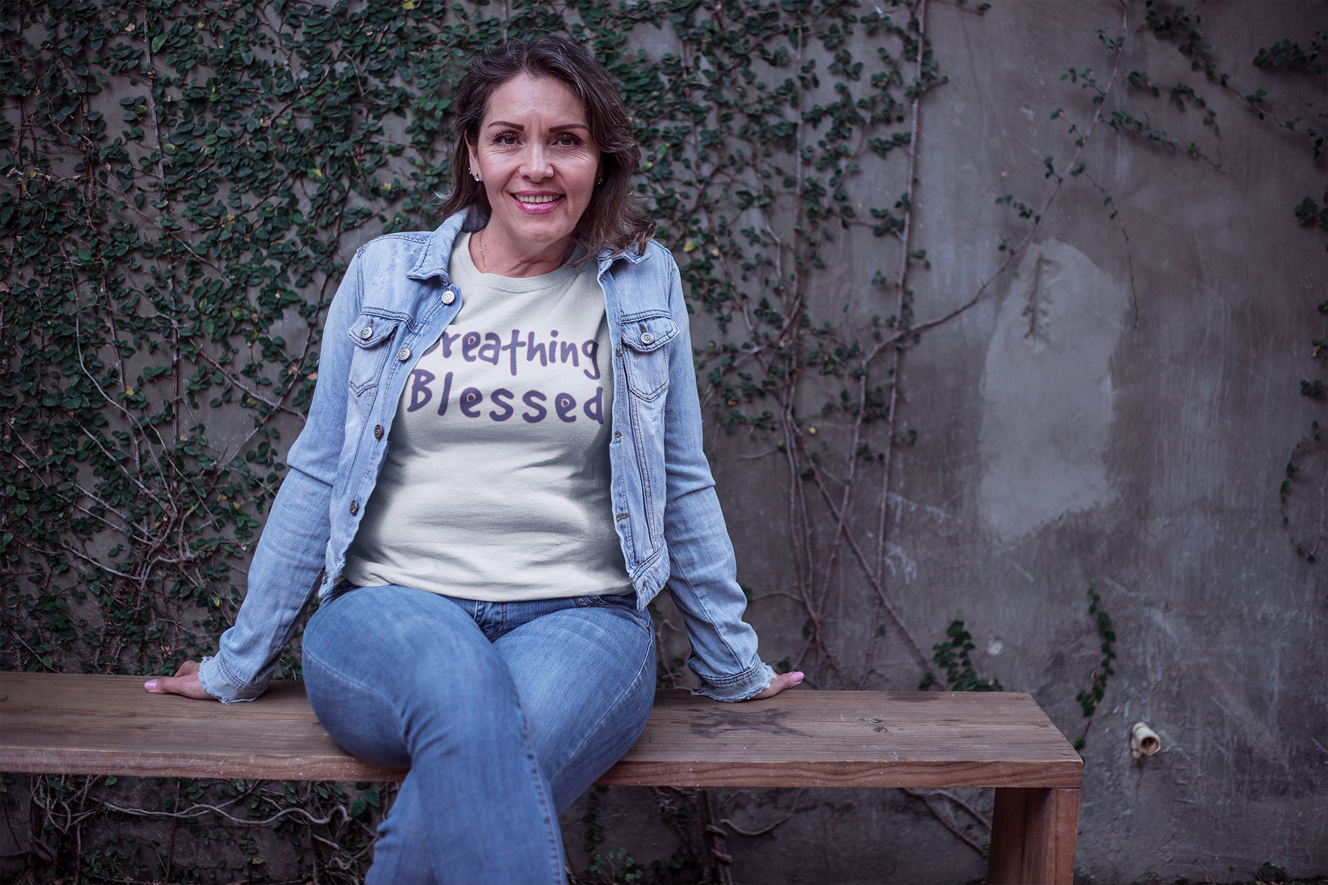 Lady in jean Jacket on a Bench Brething Logo WT Tee